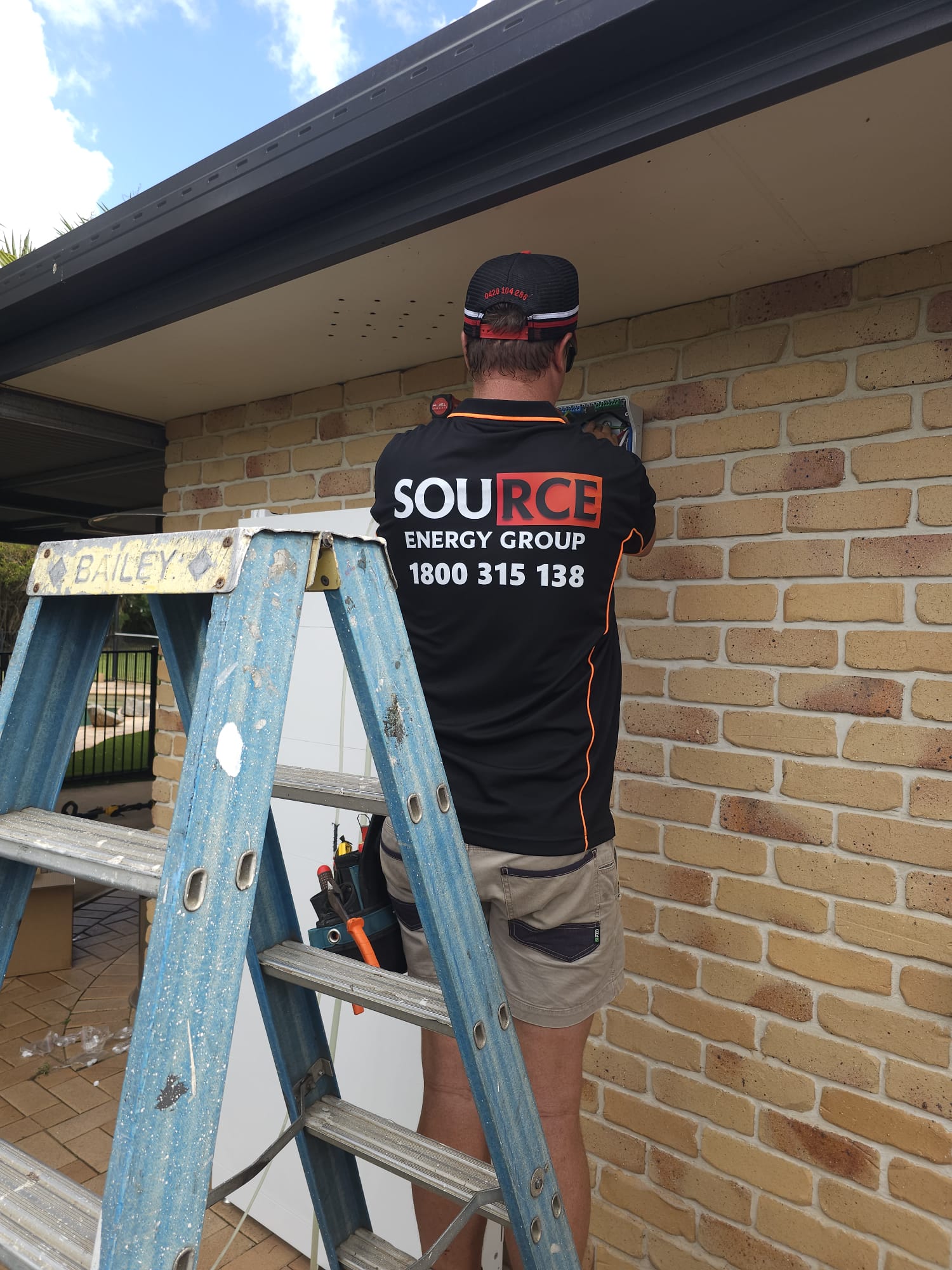 Source Energy Group technician in branded uniform completing solar installation